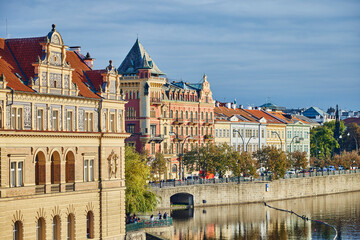 Historical architecture along the river Vltava in Prague during autumn.