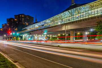 Busy Lougheed Town Centre Skytrain Station at night in motion