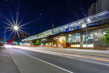 Busy Lougheed Town Centre Skytrain Station at night in motion