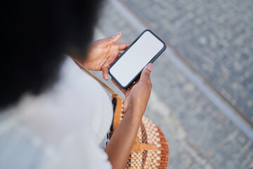 Smartphone mock-up. Closeup of woman using phone with empty screen on city street