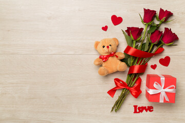 Valentines day gifts with red roses on wooden background, top view