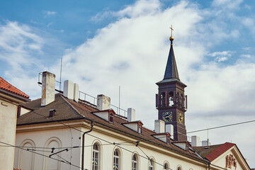 Obraz premium Clock on church tower in Prague against the sky.