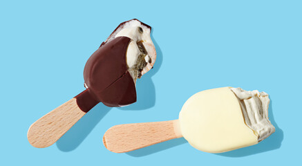 Eaten chocolate ice cream on a stick on blue pastel background