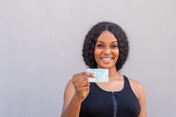 close up of a beautiful african woman from nigeria holding her voters card