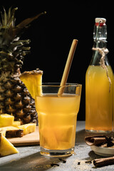 Pineapple Tepache. Fermented drink from pineapple served in glass on Dark background.