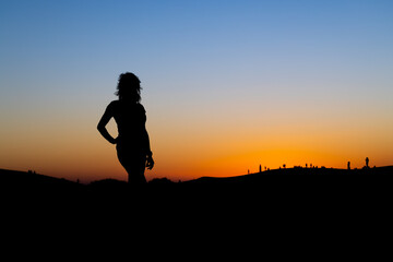 Sunset at Maspalomas Dunes - woman shadow at clear sky at sunset