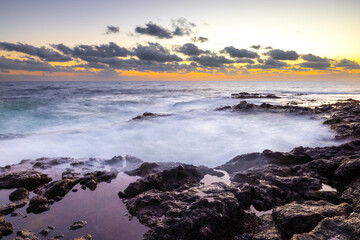 Sunset at El Bufadero natural blowhole on Gran Canaria. Ocean waves hiting rocks.