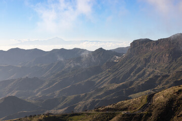 Fototapeta na wymiar Winding through the mountains: Gran Canaria's scenic drive with Teide in view