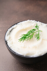 Delicious pork lard with dill in bowl on brown table