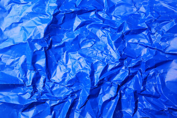Sheet of crumpled blue paper as background, top view