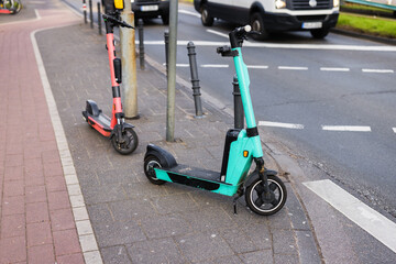 two e-scooter parking at the side of the road