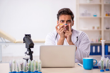 Young male chemist in drugs synthesis concept