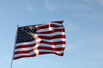 Obraz premium American flag fluttering outdoors on sunny day