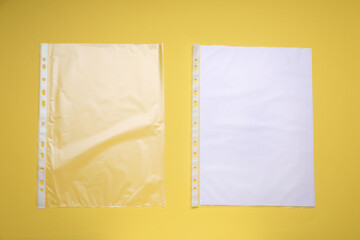Punched pockets on yellow background, flat lay. Space for text