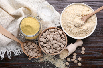 Flat lay composition with different types of brewer`s yeast on wooden table