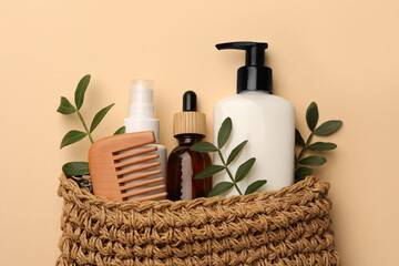 Preparation for spa. Compact toiletry bag with different cosmetic products on beige background, flat lay