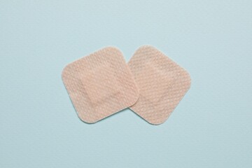 Contraceptive patches on light blue background, flat lay