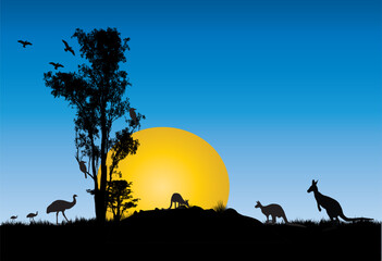 Silhouette of Gum trees with yellow moon at sunset