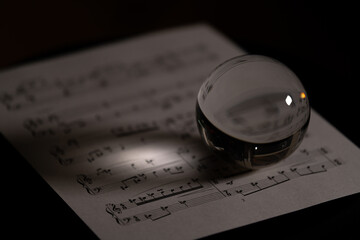 music score with glass sphere