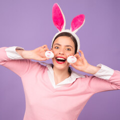 Beautiful young woman with bunny ears on studio color background. Easter funny woman with rabbit...