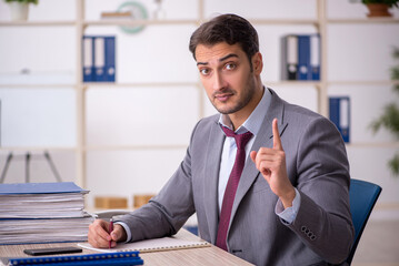 Young male employee working in the office