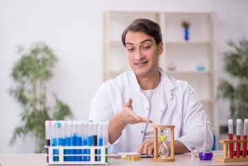 Young male chemist working at the lab