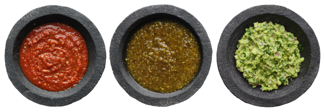 mexican salsas and guacamole in stone molcajetes shot top down and isolated