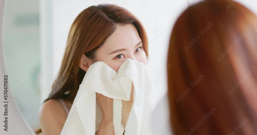 Wall mural woman clean face by towel