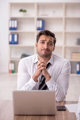 Young male employee working in the office