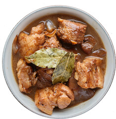 filipino adobo in bowl with bayleaves shot from top view and isolated