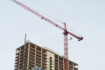 tower cranes in action view of a large construction site with buildings under construction and multi-storey residential homes