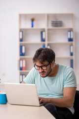 Young male student preparing for exams in the classroom