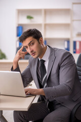 Young male employee working in the office