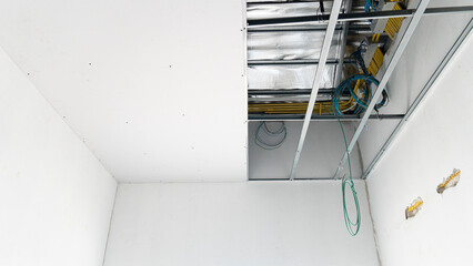 Construction of the smooth ceiling and walls has not yet been completed. Shows the equipment under...