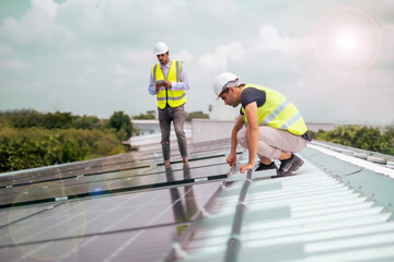 Two foreman cheking and installing solar cell plate in industrial level for factory, using green or eco energy generated to be electricity to save the world.