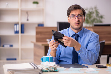 Young male accountant working in the office