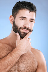 Naklejka premium Idea, beauty and skincare with a man model in studio on a blue background for natural wellness or grooming. Face, beard and skin with a handsome young male thinking about cosmetics or treatment