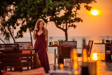 Elegant attractive smiling woman on romantic dinner in luxury gourmet restaurant