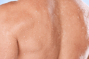 Man closeup, back and water drops for shower, fitness and skincare hygiene for cosmetics, health and dermatology. Shoulder, body zoom and person with workout, exercise or sports muscle training sweat