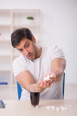 Young male student testing soft drink