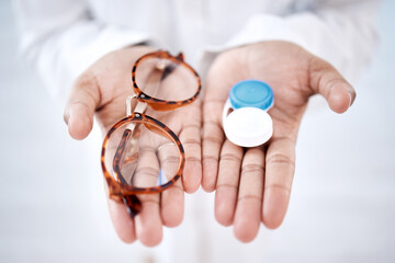 Eye care, choice with glasses or contact lenses in hands, closeup and vision with healthcare for eyes. Prescription lens, person with frame and plastic container, optometry with optician and health