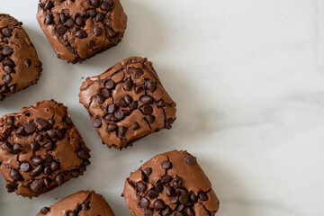 dark chocolate brownies topped by chocolate chips