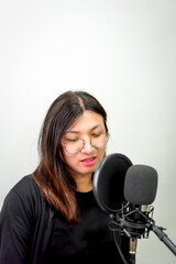Obraz na płótnie Canvas Woman (LGBTQ) singer sing a song with microphone