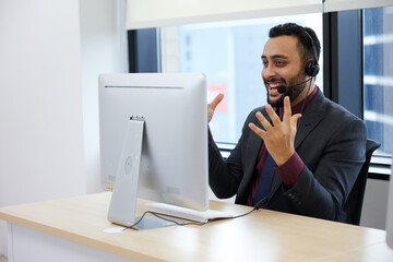 operator wearing headphones and celebrating successful after finish work at call center service