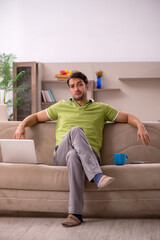 Fototapeta premium Young male freelancer working from home