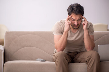 Young man sitting at home during pandemic