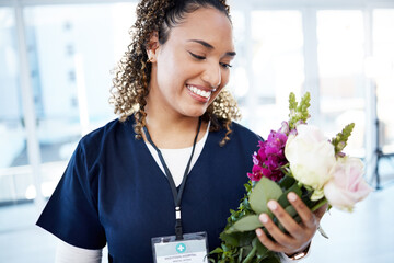Achievement, celebration and a doctor with flowers at a hospital for a promotion and gift for work. Care, happy and female nurse with a bouquet as a present for promotion in healthcare nursing job