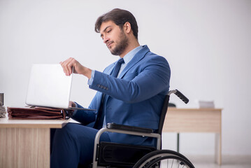 Young male employee in wheel-chair