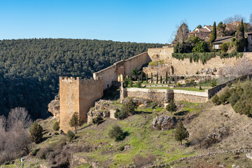 Fototapeta na wymiar Medieval houses and walls of the old town of Pedraza located on a hill in the fields of Castile, Spain.