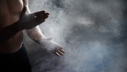 Magnesium, chalk and bodybuilder hands preparing for a workout or weight training at the gym. Fitness, talc and male athlete getting ready for bodybuilding exercise in sports center with mockup space